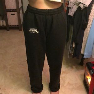 Black sweat pants with a white logo